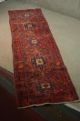 A Persian Hamadan red ground hand made runner. L.317 W.89cm.