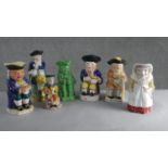 A collection of seven hand painted early 20th century ceramic Toby jugs of various designs. H.28 W.