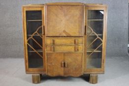 An Art Deco oak bureau sideboard, with a quarter veneered fall font enclosing a fitted interior,