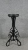 A Thonet style Bentwood jardiniere stand, with a circular plant holder on an ebonised frame of