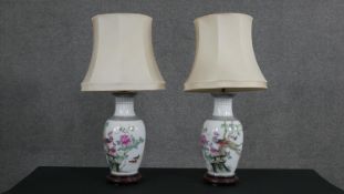 A pair of Chinese hand painted porcelain vase design table lamps, decorated with flowers and birds