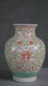 A Chinese hand painted Famille Vert porcelain vase with stylised floral and foliate design, with