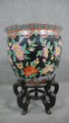 A Famille Noir Chinese hand painted fish bowl/jardinière decorated with exotic birds and flowers.