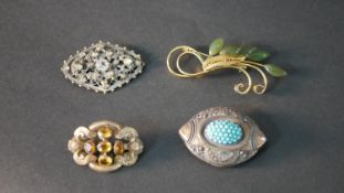 A collection of four brooches, including a Citrine set gold filled brooch, a Jade foliate brooch and