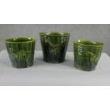 A collection of three various size 19th century pottery green glaze planters with various designs,