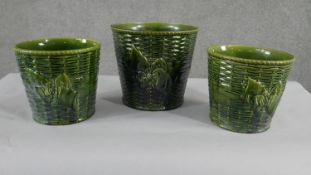 A collection of three various size 19th century pottery green glaze planters with various designs,