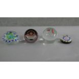 Four art glass lamp work paper weights with various designs. Makers marks to the base.