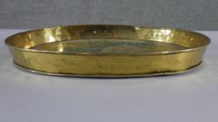 A large early 20th century twin handled brass tray. H.56 W.43cm