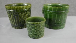 A collection of three various size 19th century pottery green glaze planters with different designs,