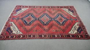 A Persian Hamadan red ground hand made rug. L.200 W.142cm.