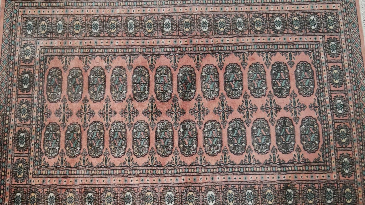 A rose ground handmade Pakistan Bokhara rug. L.150 W.100cm - Image 2 of 6