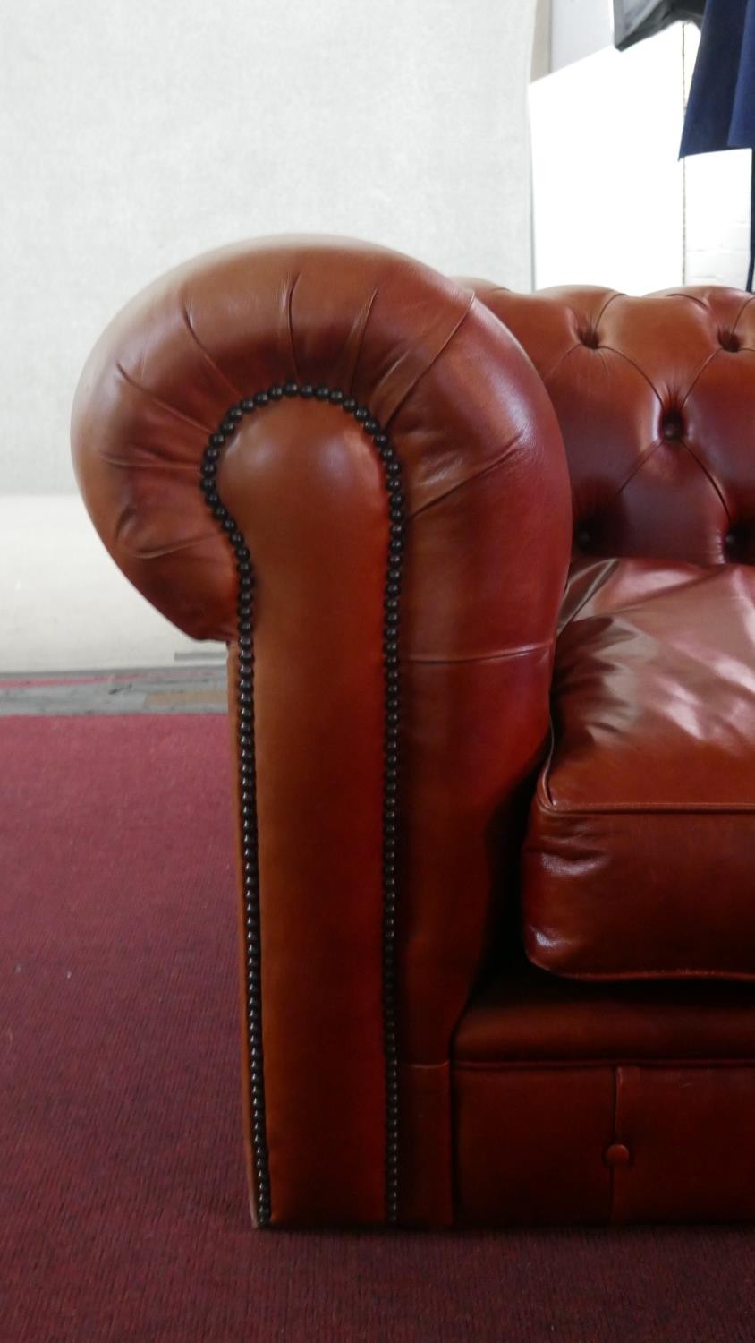 A large red leather Chesterfield sofa, with a button back and scroll arms, together with a leather - Image 5 of 8