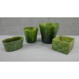 A collection of four various size and shape 19th century pottery green glaze planters with different