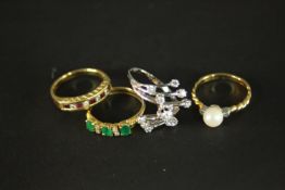Four gold gem set dress rings. A diamond and white metal abstract cross over design dress ring (O