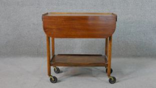 A circa 1940's mahogany drinks trolley, with drop leaves, over an undertier, on castors. H.66 W.69