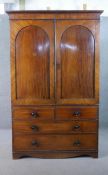 A Victorian mahogany linen press, converted to a wardrobe, with two flame mahogany doors, over two