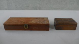 An early 20th century games box, dominoes, cards and a cribbage set along with a marquetry design