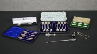 A collection of silver cutlery, including sets of silver apostle spoons, shell design coffee spoons,