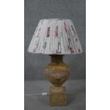 A ceramic stone effect classical design table lamp with relief fruit swag design. H.75 Diam.47cm