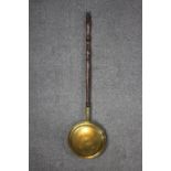 A brass bed warmer, with a turned handle. H.107 (pole) Dia. 29cm (pan).