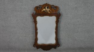A George III mahogany fretwork mirror, parcel gilt, with a carved and pierced, Ho-ho bird, and a