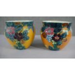 A pair of Thomas Forrester "Trogon" ware pottery jardinieres with tube-line decoration of flowers on
