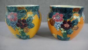 A pair of Thomas Forrester "Trogon" ware pottery jardinieres with tube-line decoration of flowers on