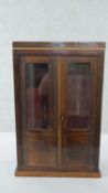 A circa 1930's miniature display cabinet, of rectangular form, with glazed doors, on a plinth