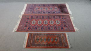 Three rust ground Bokhara motif rugs. L.130 W.67cm (Largest)