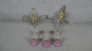Two early 20th century three branch brass ceiling lights, one with floral swag design and the