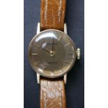 A ladies gold tone metal watch by Bulova with tan leather strap.