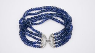 A silver and cubic zirconia, five strand faceted sapphire bead Art Deco style bracelet, each