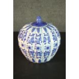 A blue and white Chinese ceramic gourd form lidded jar with stylised floral design and character