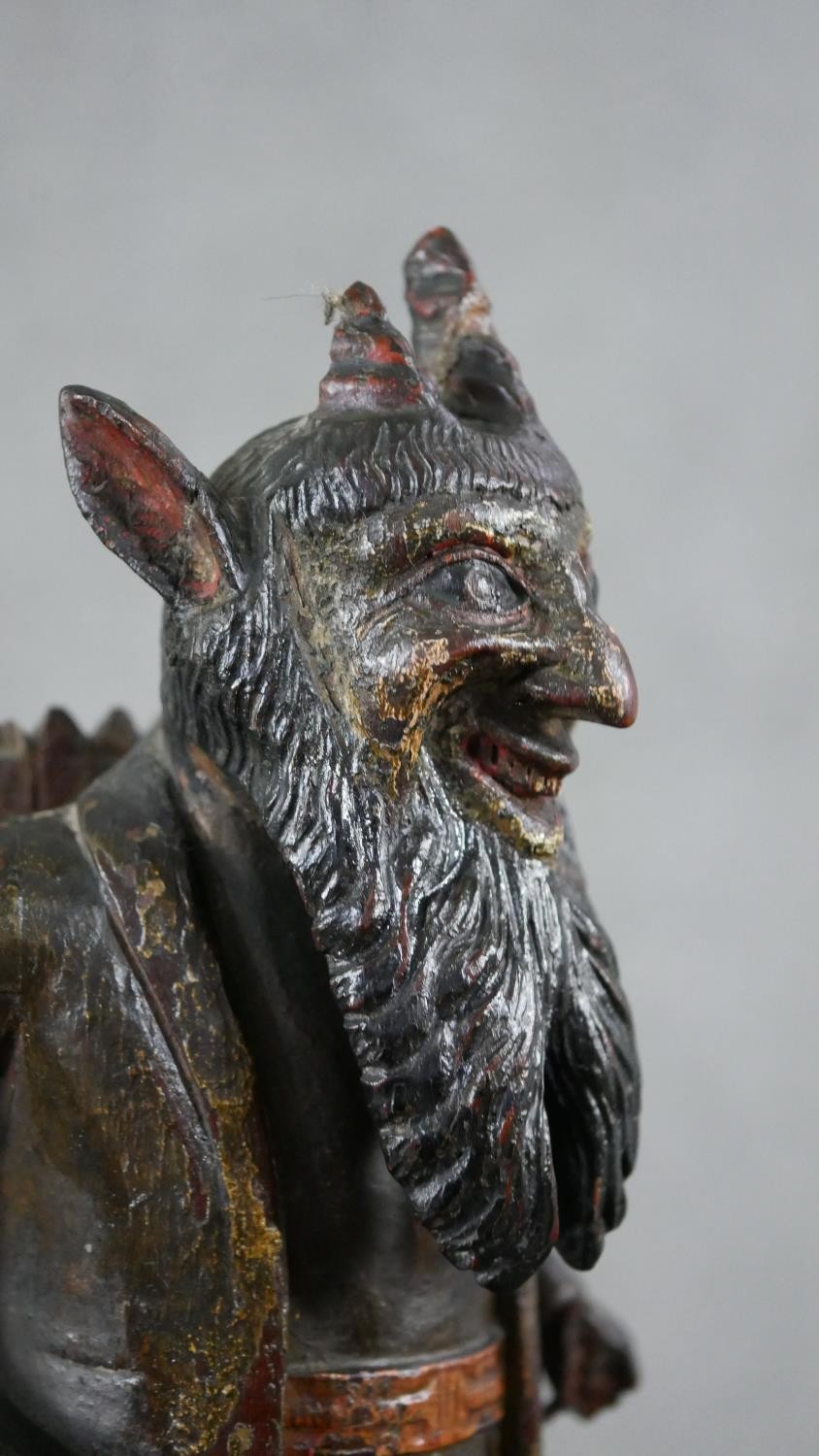 A 19th century carved black forest faun match holder, a pedestal base with red basket on his back. - Image 3 of 6