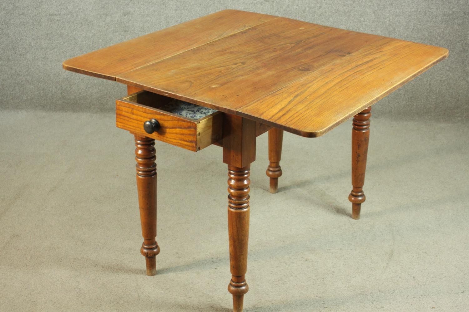 A Victorian Pembroke table, with drop leaves over an end drawer, on turned legs. H.70 W.44 D. - Image 6 of 7