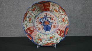 A large Japanese Imari ware hand painted bowl decorated with flowers and deer. (Restored) H.11 W.