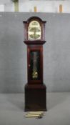A mahogany longcase clock by Fenclocks, Suffolk. The brass arch dial inscribed ‘Tempus Fugit’ with