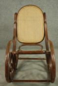 Manner of Michael Thonet, a bentwood rocking chair with a caned back and seat.