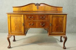 A Chippendale style Edwardian walnut kneehole sideboard, the shaped gallery back over a gadrooned