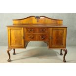 A Chippendale style Edwardian walnut kneehole sideboard, the shaped gallery back over a gadrooned