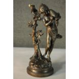 A bronze finished spelter figure after A. Moreau titled 'Fontaine et Ruisseau' of a water carrier,