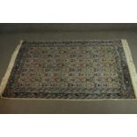 An Indian Agra part silk cream ground hand made rug. L.180 W.126cm.