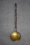A brass bed warmer, with a turned handle. H.107 (pole) Dia. 29cm (pan).