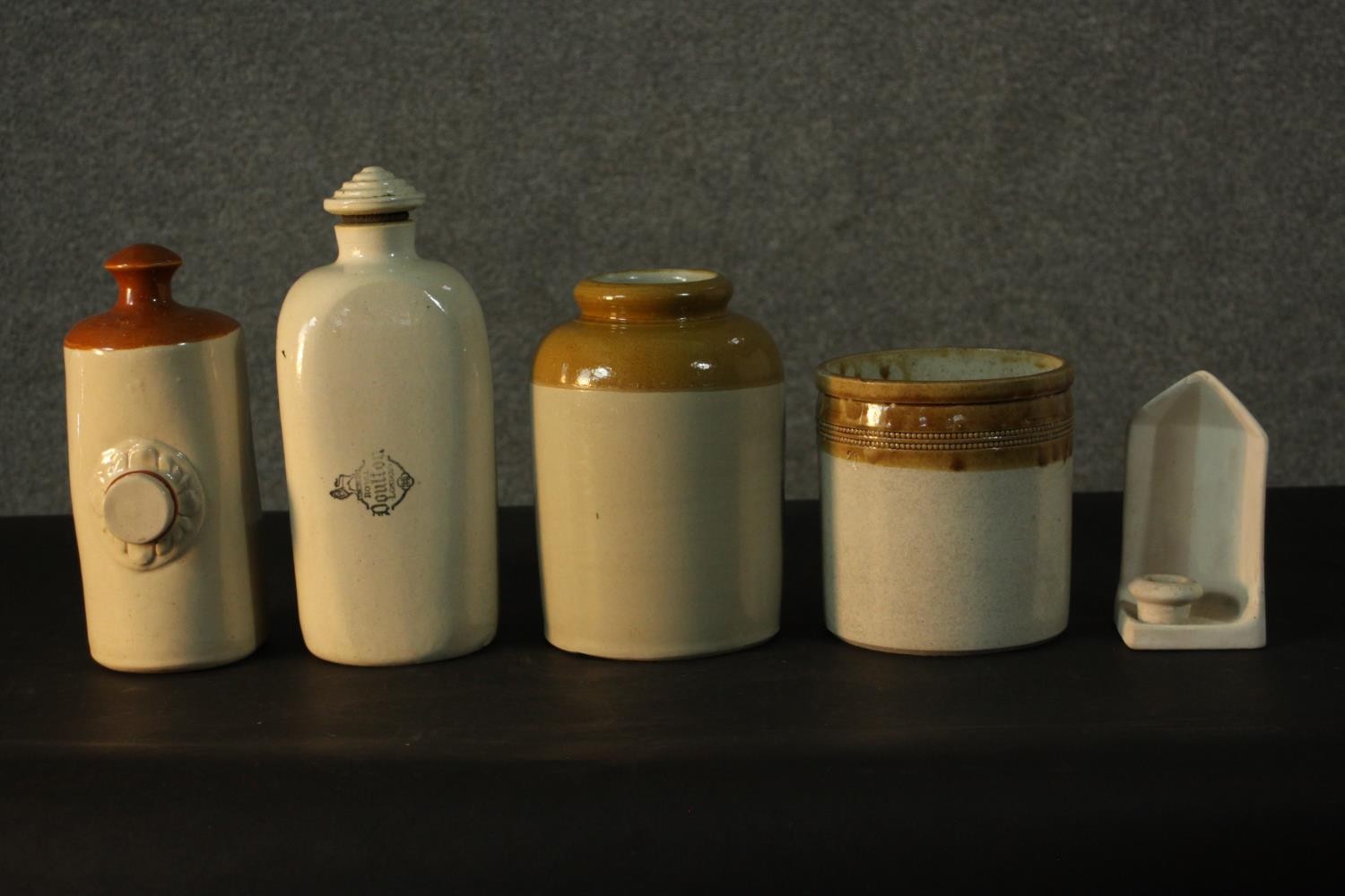 A collection of stoneware, including two Doulton Lambeth footwarmers, two food jars and a ceramic