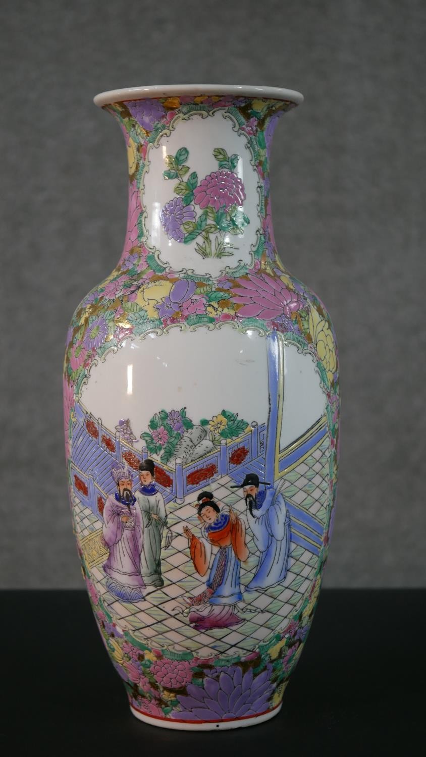 An large early 20th century Chinese Famille Rose hand painted vase, decorated with temple scenes and