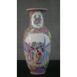 An large early 20th century Chinese Famille Rose hand painted vase, decorated with temple scenes and