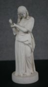 A Parian ware model of a girl, full length, standing with her arms raised. H.33 Diam.12cm