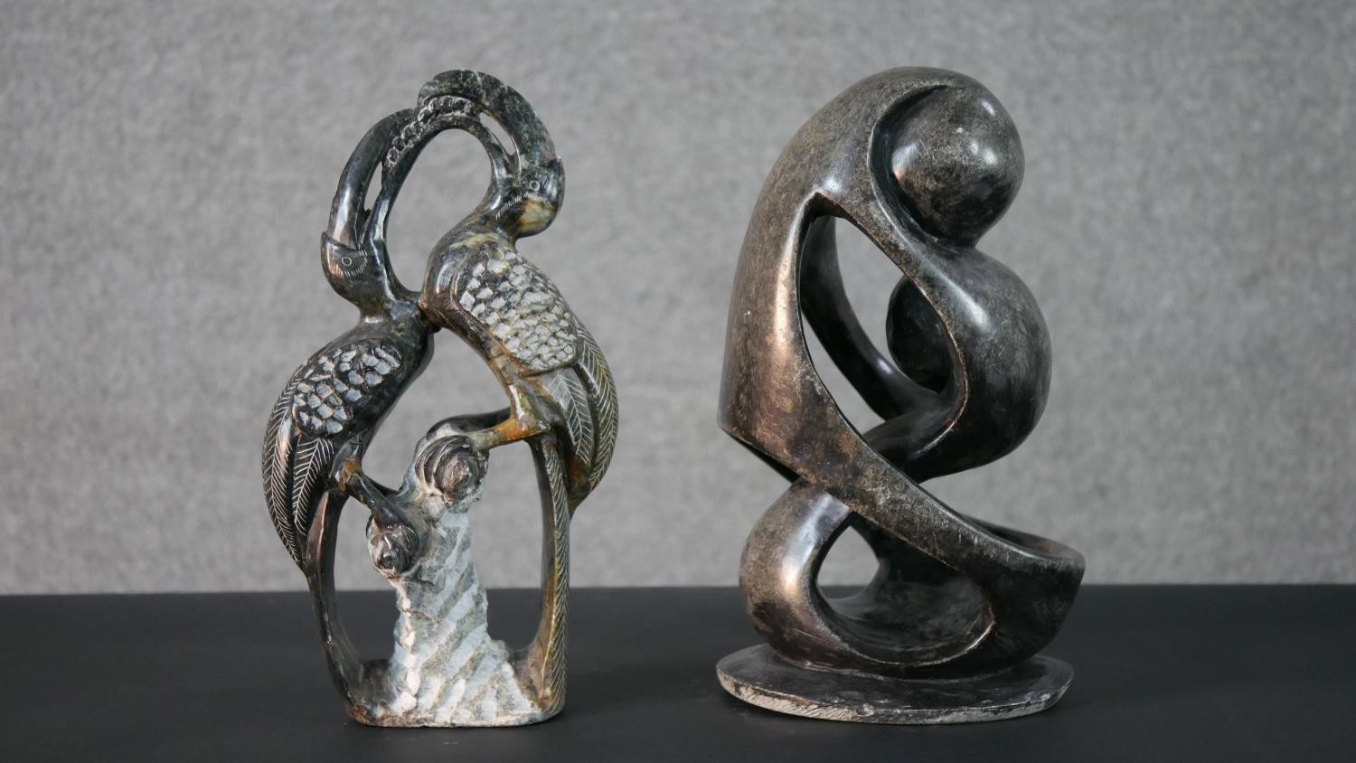 Two African carved hardstone sculptures, one of two stylised figures and the other of a pair of