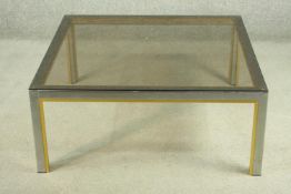 Manner of Janetti, a 1970's coffee table, with a tinted glass coffee top on a chrome and brass