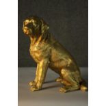 A gilded resin sculpture of a seated Labrador. H.15cm.